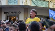 Brazilian right-wing presidential candidate Jair Bolsonaro gestures after being stabbed in the stomach during a campaign rally in Juiz de Fora, Minas Gerais State, in southern Brazil, on September 6, 2018.