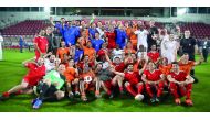 Qatar Football Association President Sheikh Hamad bin Khalifa bin Ahmed Al Thani and FIFA President Gianni Infantino pose for a photograph with participating players and officials following a friendly football tournament which took place at the Al Duhail 
