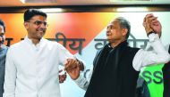 Newly-appointed Rajasthan chief minister Ashok Gehlot (R) and his newly-appointed deputy Sachin Pilot gesture as they hold hands during a press conference at the All India Congress Committee offices in New Delhi on December 14, 2018. AFP / Chandan Khanna