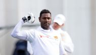 Sri Lanka's batsman Angelo Mathews celebrates reaching his century (100 runs) during day four of the first Test cricket match between New Zealand and Sri Lanka at the Basin Reserve in Wellington on December 18, 2018. AFP / Marty Melville