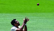 Australia's paceman Mitchell Starc takes a successful catch to dismiss India's batsman Umesh Yadav on his own bowling during day five of the second cricket match between Australia and India in Perth on December 18, 2018. AFP / William West
