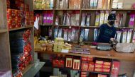 Lin Chin-hsiang, the young man who damaged three Ferraris in a single crash, works at his family’s shop selling incense and gold paper money in Taipei on December 20, 2018. AFP