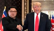 (FILES) In this file photo taken on June 12, 2018, US President Donald Trump (R) and North Korea's leader Kim Jong Un shake hands following a signing ceremony during their historic US-North Korea summit, at the Capella Hotel on Sentosa island in Singapore