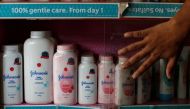 A worker closes a glass cabinet of Johnson & Johnson baby powder bottles at a medical store in Kolkata, India, December 20, 2018. REUTERS/Rupak De Chowdhuri