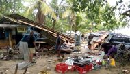 People gather salvageable items from damaged buildings on Carita beach on December 23, 2018, after the area was hit by a tsunami that may have been caused by the Anak Krakatoa volcano. AFP / Semi