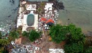 An aerial photo shows damaged buildings in Carita on December 23, 2018, after the area was hit by a tsunami on December 22 following an eruption of the Anak Krakatoa volcano.  AFP / Azwar Ipank