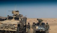  In this file photo taken on September 13, 2018 US-backed forces are pictured near the village of Susah in the eastern province of Deir Ezzor, near the Syrian border with Iraq. / AFP / STR 