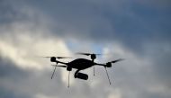 In this file photo taken on December 14, 2017 a surveillance drone silhouettes against the cloudy sky during the handover of 50 new vehicles and equipment to the federal police in Potsdam, eastern Germany. / AFP / Tobias SCHWARZ