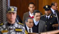 Former Egyptian president Hosni Mubarak (C, front), who was ousted following a popular uprisal in 2011, arrives with his sons Alaa (C-R) in southern Cairo on December 26, 2018. / AFP / MOHAMED EL-SHAHED
