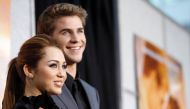 FILE PHOTO: Cast member Miley Cyrus and co-star Liam Hemsworth pose at the premiere of 