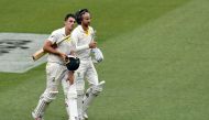 Australia's unbeaten batting pair Pat Cummins (L) and Nathan Lyon walk back to the pavilion at the end of fourth day's play of the third cricket Test match between Australia and India in Melbourne on December 29, 2018. AFP / WILLIAM WEST /