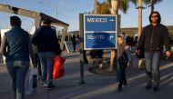  Pedestrians, coming from Mexico, exit the San Ysidro Port of Entry along the US/Mexico border on Saturday, December 29, 2018 in San Ysidro, California. President Donald Trump has threatened to shut down the border if he doesn't get over 5 Billion in fund