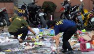Police officers investigate at the site of an explosion outside a shopping mall in Cotabato City on the southern island of Mindanao on December 31, 2018. AFP 