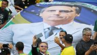 Supporters of Brazil's new President Jair Bolsonaro take pictures as they gather outside the Planalto Palace ahead of Bolsonaro's swear-in ceremony, in Brasilia, Brazil, January 1, 2019. REUTERS/Sergio Moraes