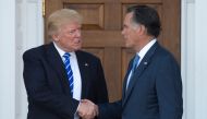 In this file photo taken on November 19, 2016 US President-elect Donald Trump shakes hands with Mitt Romney after their meeting at the clubhouse of Trump National Golf Club in Bedminster, New Jersey. (AFP / Don EMMERT)