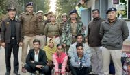 Members of a Muslim Rohingya family sit as they pose for a photograph with Indian and Myanmar security officials before their deportation on India-Myanmar border at Moreh in the northeastern state of Manipur, India, January 3, 2019. REUTERS/Stringer