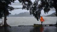 A man guards an empty pier after tour operators were forced to suspend boats to tourist islands due to tropical storm Pabuk, in the southern Thai province of Surat Thani on January 4, 2019. AFP / Lillian SUWANRUMPHA