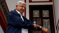 FILE PHOTO: Mexico's president-elect Andres Manuel Lopez Obrador shows his watch following a question by a reporter after a news conference in Mexico City, Mexico July 22, 2018. REUTERS/Ginnette Riquelme/File Photo