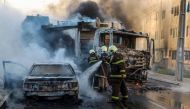 Firefighters putting out a burning truck and car during a wave of gang violence in Brazil's northeastern Ceara state, in the Conjunto Palmeiras neighborhood, city of Fortaleza, Ceara state, Brazil on January 3, 2019.  AFP PHOTO / O POVO / ALEX GOMES