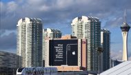 A monorail train plastered with a Google advertisement passes a giant sign from Apple on a building as preparations are underway for the CES 2019 show, January 6, 2018 in Las Vegas, Nevada. AFP / Robyn Beck