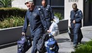 Victoria Police forensic officers remove a bag from the Italian consulate in Melbourne on January 9, 2019. / AFP / William WEST 
