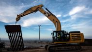A construction crew works on replacing the US-Mexico border fence as seen from Tijuana, in Baja California state, Mexico, on January 9, 2019.  AFP / Guillermo Arias
 