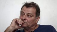 In this file photo taken on October 20, 2017 Italian ultra-leftist militant Cesare Battisti gestures during an interview with AFP in Cananeia, Sao Paulo state, Brazil. / AFP / Miguel SCHINCARIOL 