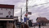 A man walks next to the portrait of the Serbian President displayed at the office of a Serbian political party in the town of Gracanica near Pristina, on December 29, 2018. AFP / Armend Nimani 