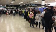 Passengers flying from Miami International Airport wait in line to enter the checkpoint at Concourse F, where some of the flights of a closed terminal were diverted, in Miami, Florida, on January 13, 2019. AFP / Leila MACOR