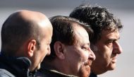 Italian former communist militant Cesare Battisti (C), wanted in Rome for four murders attributed to a far-left group in the 1970s, is escorted by Italian Police officers after stepping off a plane coming from Bolivia and chartered by Italian authorities,