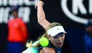 Denmark's Caroline Wozniacki hits a return against Belgium's Alison Van Uytvanck during their women's singles match on day one of the Australian Open tennis tournament in Melbourne on January 14, 2019. AFP / Jewel Samad 