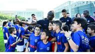 PSG forward Moussa Diaby takes a selfie with young kids during the inauguration ceremony of the club’s sports academy in Doha, yesterday. 