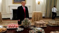 US President Donald Trump speaks in front of fast food provided for the 2018 College Football Playoff National Champion Clemson Tigers due to the partial government shutdown in the State Dining Room of the White House in Washington, U.S., January 14, 2019