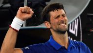 Serbia's Novak Djokovic celebrates his victory against Mitchell Krueger of the US during their men's singles match on day two of the Australian Open tennis tournament in Melbourne on January 15, 2019. AFP / Paul Crock 