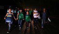 Honduran migrants, part of the second caravan to the United States, leave San Pedro Sula, 180 km north of Tegucigalpa, on January 14, 2019. AFP / ORLANDO SIERRA
