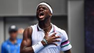 Frances Tiafoe of the US celebrates his victory against South Africa's Kevin Anderson during their men's singles match on day three of the Australian Open tennis tournament in Melbourne on January 16, 2019. 