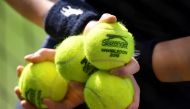 A ball boy holds balls during at Wimbledon All England Lawn Tennis and Croquet Club, London, July 9, 2018. Reuters/Toby Melville