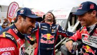 Al Attiyah (left) and his French co-driver Mathieu Baumel (right) share a light moment with Mini’s co-driver David Castera of France at the end of the Dakar Rally Stage 7 around San Juan de Marcona, in Peru.
