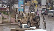 An image grab taken from a video obtained by AFPTV on January 16, 2019, shows US troops gathered at the scene of a suicide attack in the northern Syrian town of Manbij. AFP / ANHA 