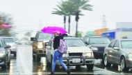 Pedestrian crosses a street in the rain in Montebello, California on January 16, 2019 as southern California is hit by another storm, pushed by an atmospheric river, with rainfall expected to get heavier later into the day.  AFP / Frederic J Brown

