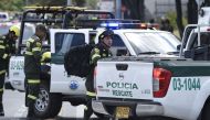 Security forces work at the site of an apparent car bomb attack on a police cadet training school in Bogota, that left at least four people dead and 10 injured on January 17, 2019.  AFP / Juan Barreto