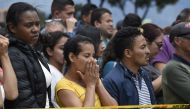 People wait for news outside the site of an explosion on a police cadet training school in Bogota on January 17, 2019. AFP / Juan Barreto
 
