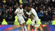 Real Madrid's Brazilian midfielder Casemiro (R) celebrates with Real Madrid's Spanish defender Dani Carvajal after scoring a goal during the Spanish League football match between Real Madrid and Sevilla at the Santiago Bernabeu stadium in Madrid on Januar