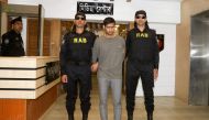 The Rapid Action Battalion (RAB) escort arrested suspected militant Mamunur Rashid (C) in Dhaka on January 20, 2019.  / AFP / STR