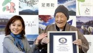 FILE PHOTO: Japanese Masazo Nonaka, who was born 112 years and 259 days ago, receives a Guinness World Records certificate naming him the world's oldest man during a ceremony in Ashoro, on Japan's northern island of Hokkaido, in this photo taken by Kyodo 