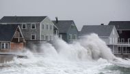 Waves crash over homes on Lighthouse Road during a winter storm that brought snow, sleet and rain to the area on January 20, 2019 in Scituate, Massachusetts. Icy conditions are predicted for much of Massachusetts. (Scott Eisen/Getty Images/AFP)