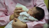 This photo taken on January 19, 2019 shows a medical staff taking care of a new born baby at a hospital in Fuyang in China's eastern Anhui province. China OUT / AFP / STR 