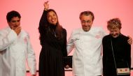 Newly awarded three-star Michelin chefs, Chef Laurent Petit, for his restaurant Le Clos des Sens in Annecy, and Chef Mauro Colagreco, for his restaurant Mirazur in Menton, react on stage with their wives during the Michelin Guide 2019 award ceremony in Pa
