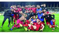 Qatari players celebrate after defeating Iraq 1-0 in AFC Asian Cup UAE 2019 Round of 16 match at the Al Nahyan Stadium in Abu Dhabi on Tuesday.
