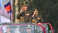 Cambodian Prime Minister Hun Sen (L) salutes accompanied by his son, Commander of Cambodian Infantry Army, Lieutenant General Hun Manet (R) during an inspection of troops at a ceremony marking the 20th anniversary of the formation of Cambodian Infantry Ar